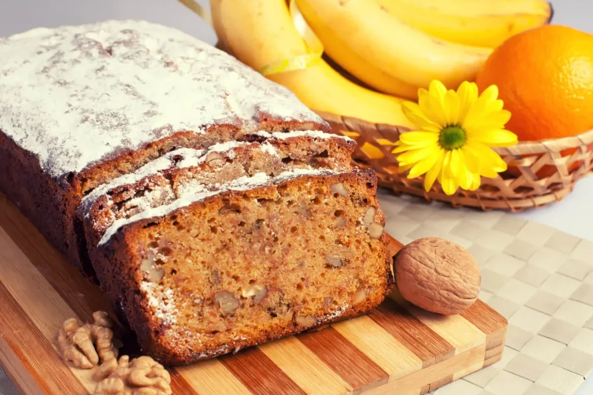 A slice of banana bread, reminiscent of Starbucks' offering, with a light sugar dusting.