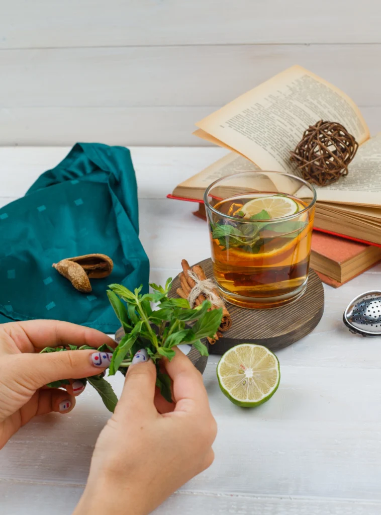 Preparing a green tea infusion with fresh ingredients for a homemade green tea shot.