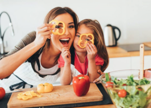 Emma and her daughter cooking together in the kitchen, showcasing family recipes from Recipes Vibes.