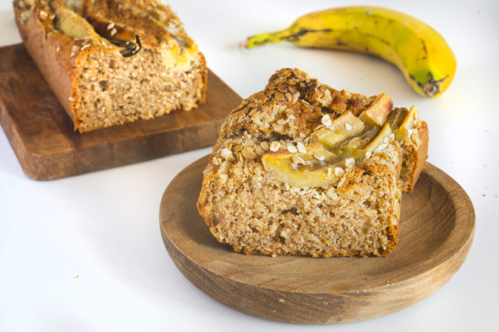 Moist banana bread slice on a plate with a fork