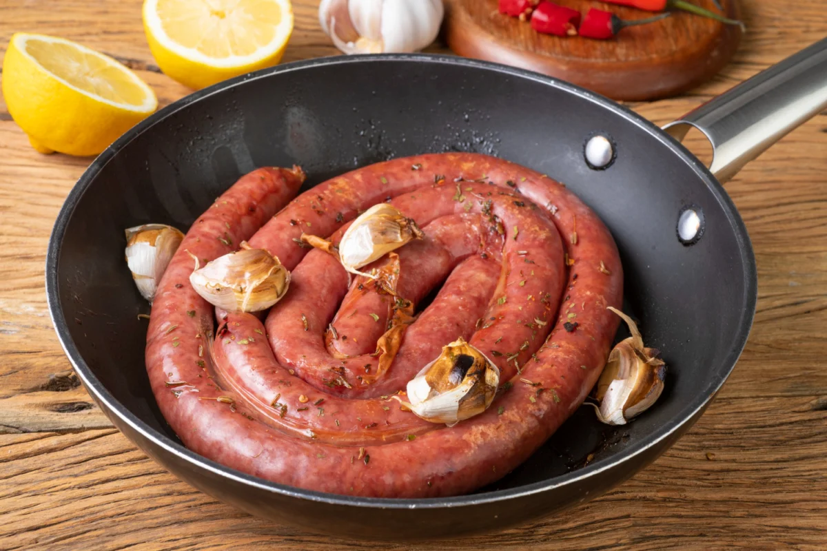 Sliced kielbasa on a cutting board, ready for cooking