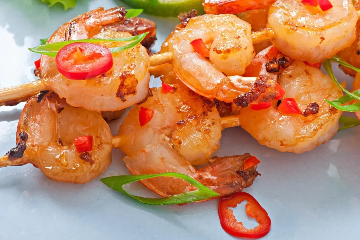  Grilled shrimp skewers with fresh garnishes, echoing the culinary style that led to Bang Bang Shrimp.