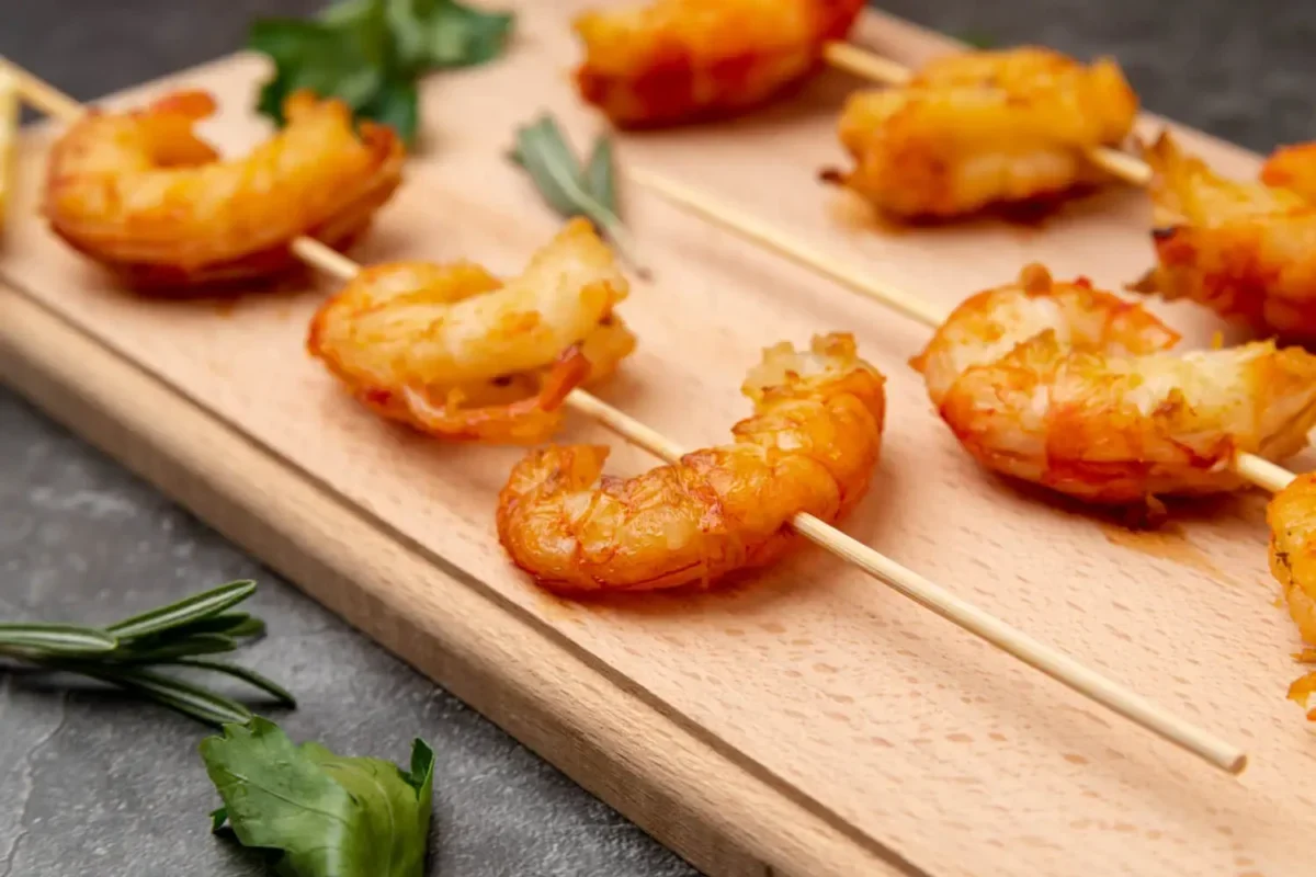 Shrimp skewers reminiscent of the original Bang Bang Shrimp, inviting thoughts on its invention.