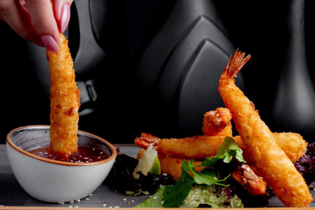 Hand-dipped fried shrimp with tangy sauce, an appetizing take on bang bang shrimp.