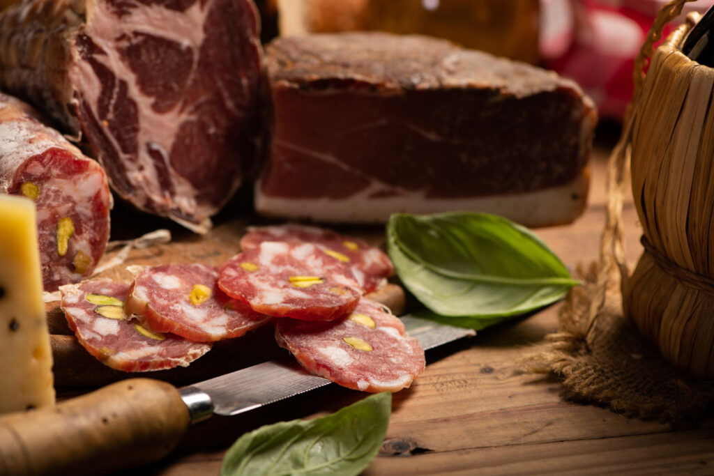 Soppressata slices on a rustic wooden board